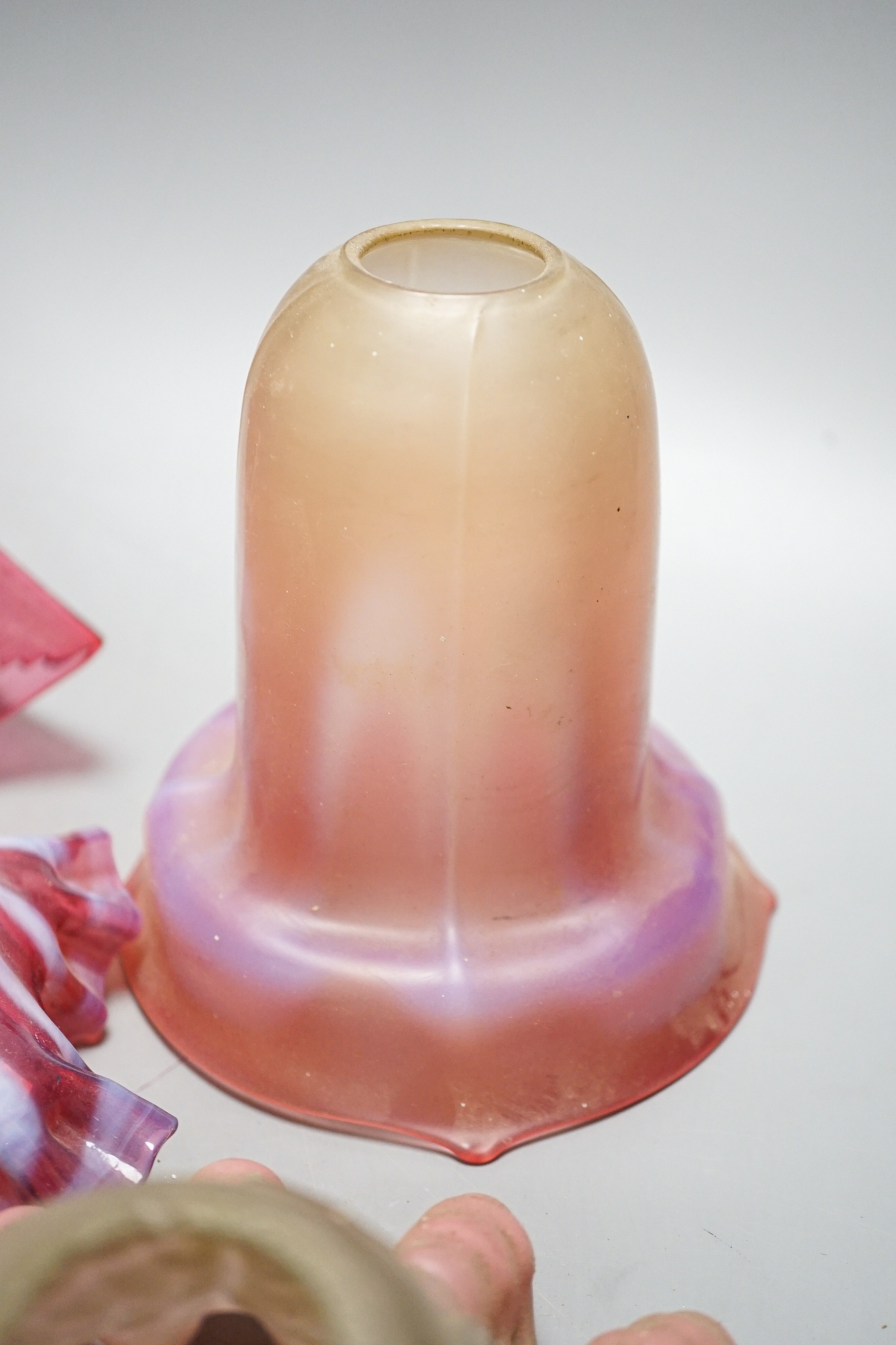 Six various cranberry glass lamp shades, two with opalescence, largest 16 cms high.